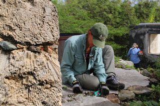 Clearing vegetation at Lameshur Bay. Next to the volunteer is a chimney made of coral