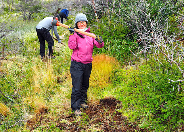 trail volunteer with pick mattock